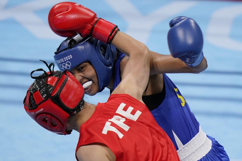 Taiwan's Wu Shih-Yi, bottom, exchanges punches with Sweden's Agnes Alexiusson during their women's lightweight 60-kg boxing match