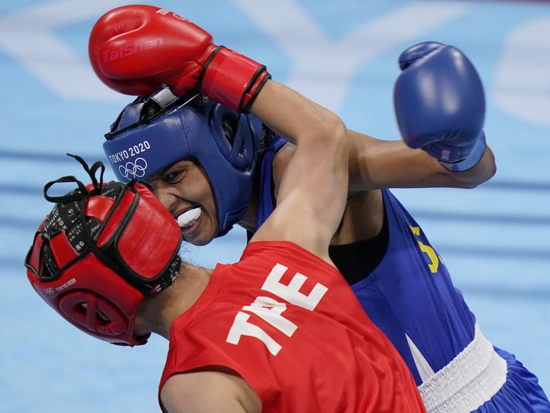 Taiwan's Wu Shih-Yi, bottom, exchanges punches with Sweden's Agnes Alexiusson during their women's lightweight 60-kg boxing match