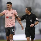 John Egan speaks to referee Keith Stroud during last season's FA Cup match at Bristol Rovers: Darren Staples/Sportimage
