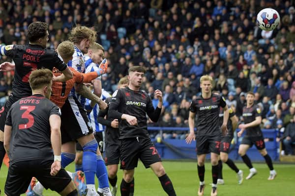 OPENING SALVO: Sheffield Wednesday's Michael Smith leaps highest to open the scoring at Hillsborough against Lincoln City. Picture: Steve Ellis