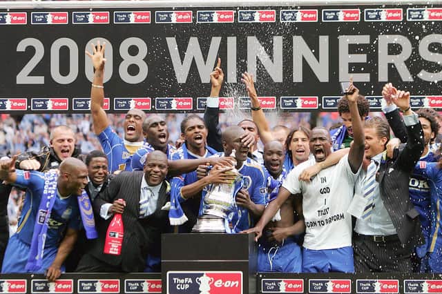 The Portsmouth team celebrate with the FA Cup trophy after their FA Cup final match against Cardiff City at Wembley football Stadium, London on May 17, 2008. Portsmouth won the match 1-0.  AFP PHOTO / CARL DE SOUZA (Photo credit should read CARL DE SOUZA/AFP via Getty Images)