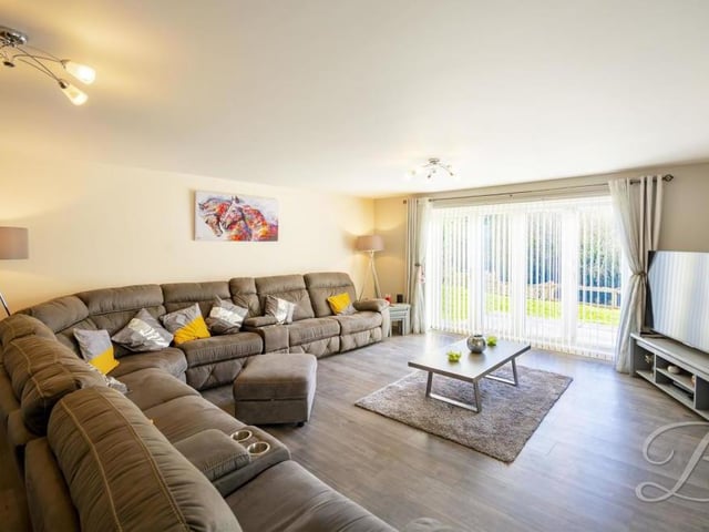 It's not hard to imagine relaxing evenings or weekends in this spacious lounge. Bi-folding doors lead out into the garden at the back of the property.
