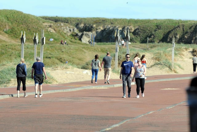 Couples can be seen walking together and keeping their distance from others.