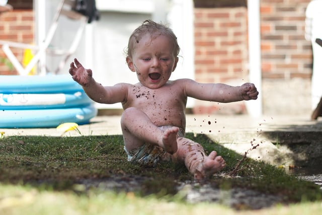 2013 Winner. Noah Denholm, who was a few days short of turning 1 years old at the time, in his Nanny and Grandad's garden. The paddling pool has just been emptied which made a tempting puddle of mud on the grass.  He loved splashing about in it and getting himself dirty.