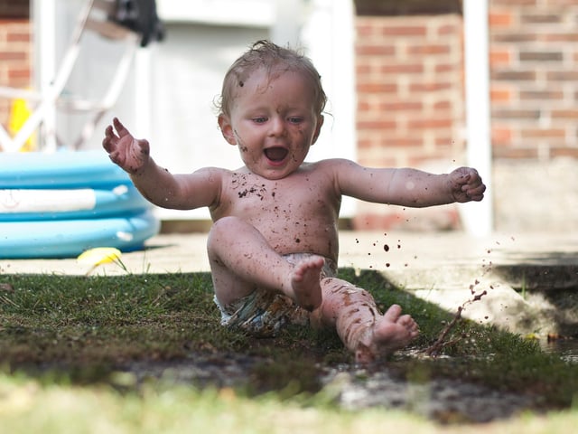 2013 Winner. Noah Denholm, who was a few days short of turning 1 years old at the time, in his Nanny and Grandad's garden. The paddling pool has just been emptied which made a tempting puddle of mud on the grass.  He loved splashing about in it and getting himself dirty.