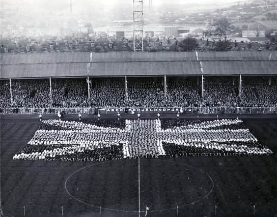 Queen Elizabeth II visit to Sheffield 27th October 1954 - Hillsborough Football Ground
Sheffield schoolchildren come to the climax of their tableau as they bow down before the Queen and form the Union Jack