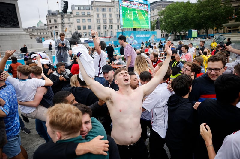 Fans in London hug as England go through to the quarter final which will be played on Saturday, 3 July (AFP via Getty Images)