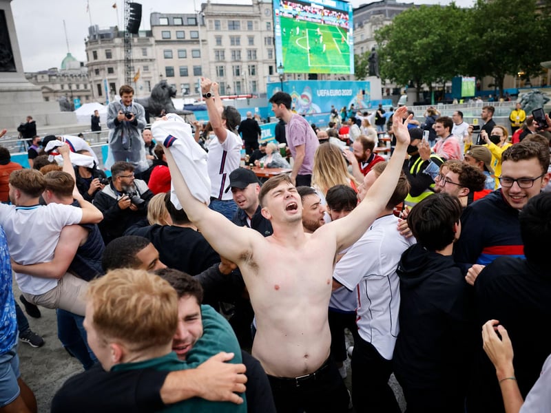 Fans in London hug as England go through to the quarter final which will be played on Saturday, 3 July (AFP via Getty Images)