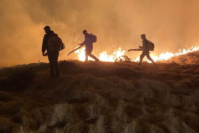 Peak District Moorland Group gamekeepers tackling the blaze at Marsden Moor