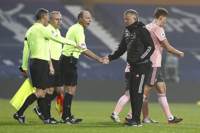 Sheffield United's manager Chris Wilder shakes hands with the match officials following the English Premier League soccer match between West Bromwich Albion and Sheffield United at The Hawthorns: Jason Cairnduff/Pool via AP