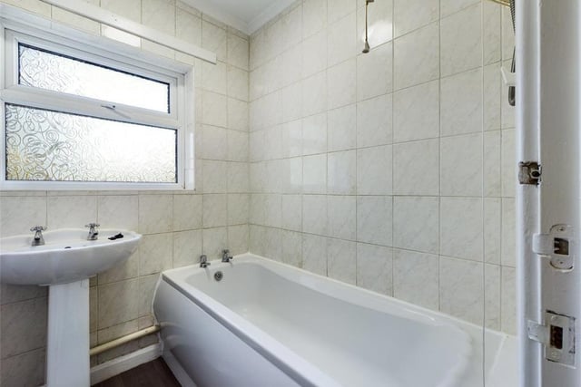 Family Bathroom - Pannelled bath with electric shower unit over and pedestal wash basin; uPVC double glazed window to the side elevation, tiled walls, extractor fan and radiator panel.