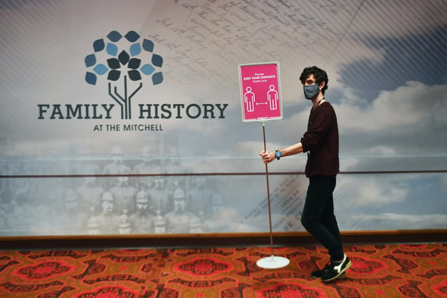 Michael Gallacher, archivist places a sign at the Mitchell.