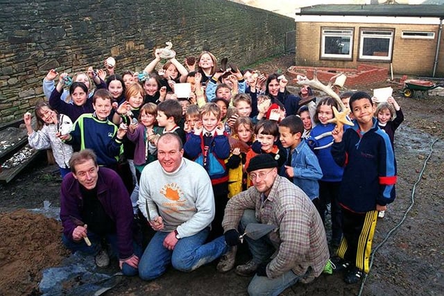 Pictured at Westways Primary School, Sheffield, where Broadleaf Conservation members are working with children from the school to create a wildlife garden. Pupils were asked to bring objects into school that could be built into the walls that will be made in the garden. Seen are pupils with builders, left to right,  Reg Fields, John Hanson, and Brian Hemingway, January 1999