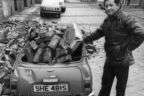 David Howitt with his Mini after gales damaged a wall in Nottingham Cliff, Pitsmoor and it collapsed on to his car 1983