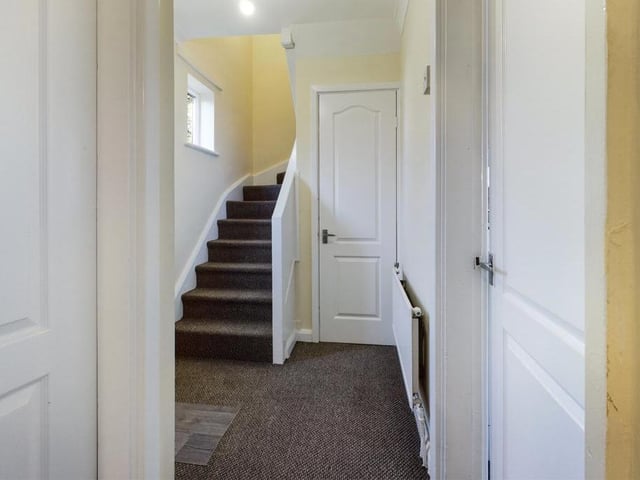 Entrance Hall - uPVC double window and uPVC double glazed exterior entry door to the front elevation, ceiling coving, under-stairs storage cupboard, radiator panel, cloakroom WC; stairs to first floor leading off.