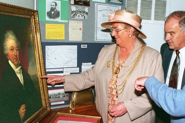 At a reunion in 1997 - ex-pupils look upon a painting of the founder of the trust Rev William Car Fenton.