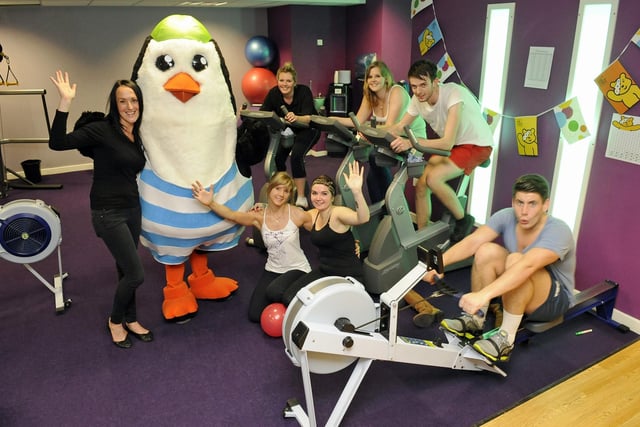 2012. Staff in 'The Gym' at the Pyramids in Southsea set themselves the challenge of running, rowing and cycling for Children in Need.
(left to right) Shirley Ellis (31), with 'Percy the Penguin ', Vickie Petrie (21), Emily Brewster (18), Rob Powell (19) and Ryan White (21)
(front left to right) Kimberley Bridger (24) and Francesca Silvano (20)
Picture: Malcolm Wells (123766-8780)