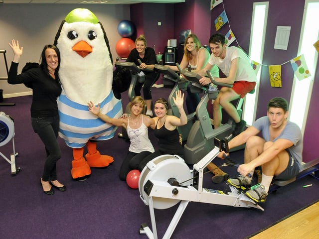2012. Staff in 'The Gym' at the Pyramids in Southsea set themselves the challenge of running, rowing and cycling for Children in Need.
(left to right) Shirley Ellis (31), with 'Percy the Penguin ', Vickie Petrie (21), Emily Brewster (18), Rob Powell (19) and Ryan White (21)
(front left to right) Kimberley Bridger (24) and Francesca Silvano (20)
Picture: Malcolm Wells (123766-8780)