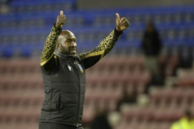 Sheffield Wednesday manager Darren Moore saluting the travelling fans at Wigan Athletic.