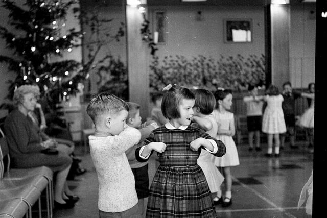 Children dance at the Parsons Green School Infants Christmas Party in 1962.