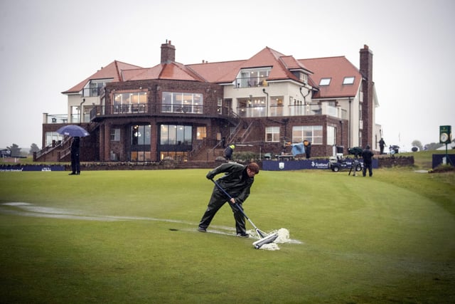 Ground staff at work clearing the waterlogged green on the 18th due to heavy rain during the third round of the Aberdeen Standard Investments Scottish Open at The Renaissance Club, North Berwick.