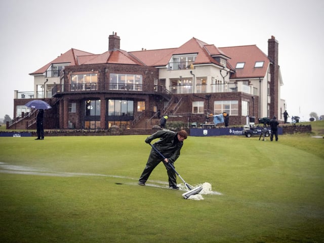 Ground staff at work clearing the waterlogged green on the 18th due to heavy rain during the third round of the Aberdeen Standard Investments Scottish Open at The Renaissance Club, North Berwick.