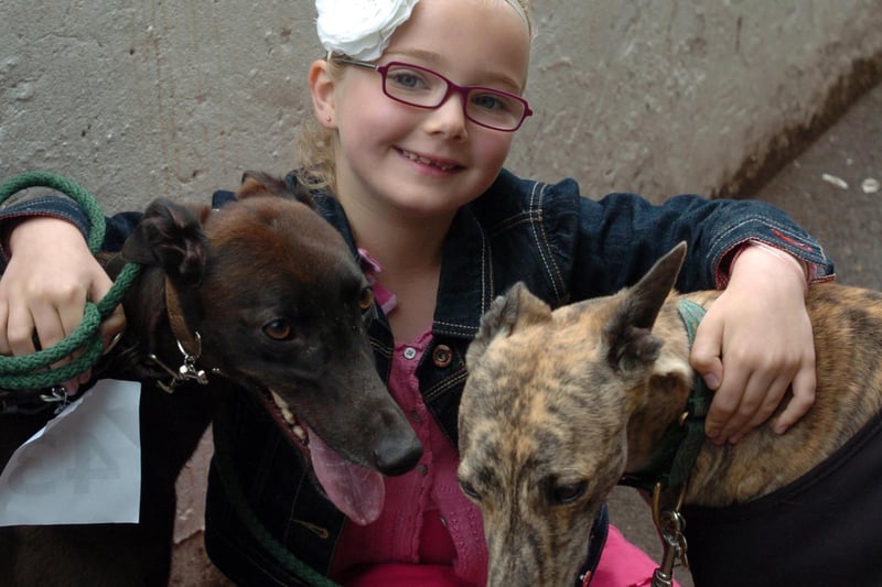 Mia Cockayne, aged seven, at a Doggy Fun Day held in Owlerton Stadium in July 2010 with greyhounds Tilly, left, and Sheelagh