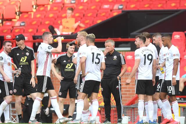 Chris Wilder, Manager of Sheffield United speaks to his team during a drinks break during the Premier League match between Manchester United and Sheffield United at Old Trafford on June 24, 2020 in Manchester, England. (Photo by Michael Regan/Getty Images)