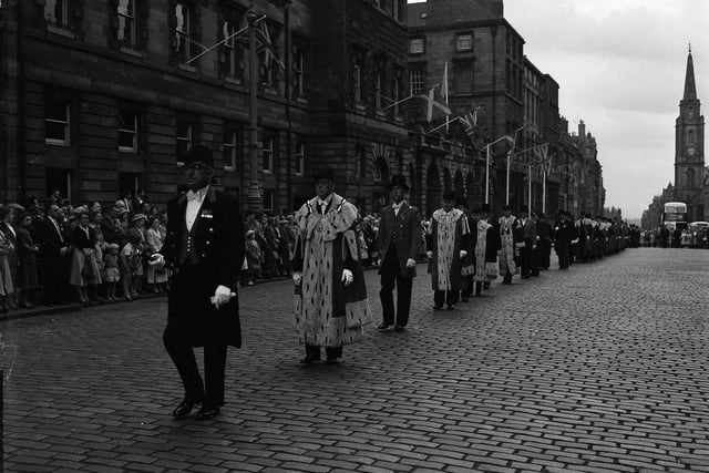 In the 1950s and 1960s a procession up the Royal Mile marked the start of the Edinburgh Festival. Lord Provost Johnson-Gilbert and other dignitaries are pictured leading the parade in August 1959.