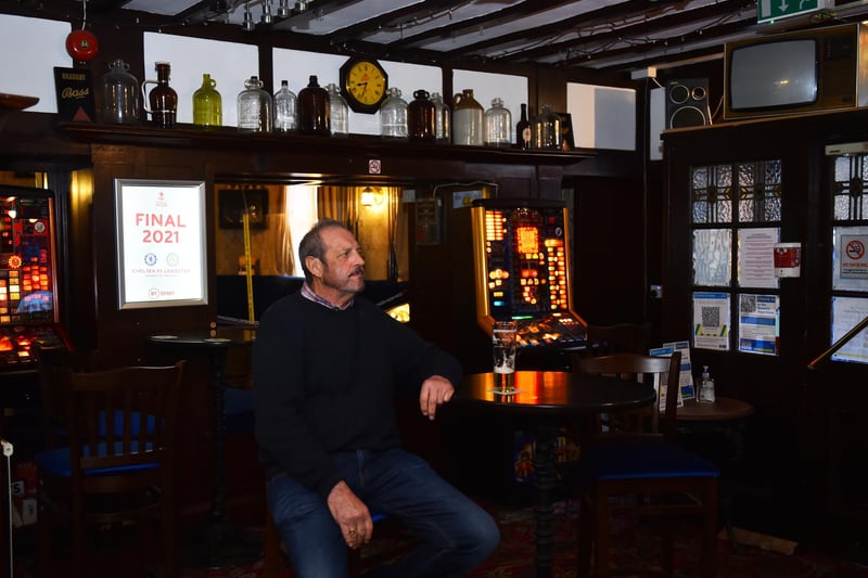 A man enjoys a drink at The Queens Head pub. (Photo by Nathan Stirk/Getty Images)