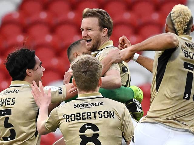 James Coppinger is mobbed by his teammates after his sensational equaliser against Hull City. Photo: Andrew Roe