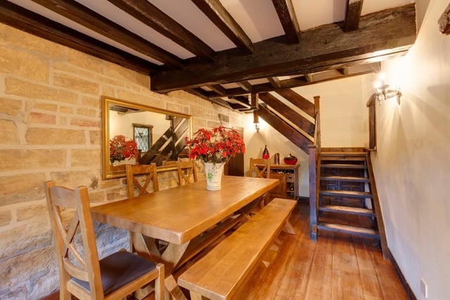 The dining area's exposed timber beams and reclaimed oak flooring add character.