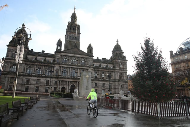 A cyclist makes his through a quiet George Square in Glasgow.