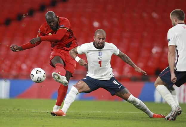 Belgium's Romalu Lukaku gets in a shot despite the challenge of England's Kyle Walker (AP Photo/Ian Walton, Pool)