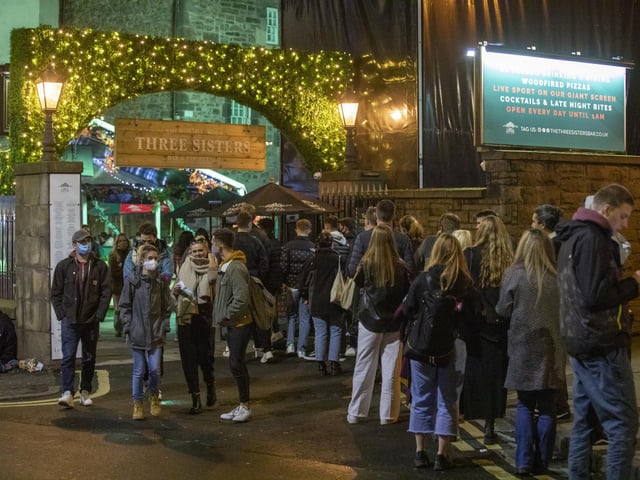Drinkers queue outside The Three Sisters on Cowgate on Thursday night.