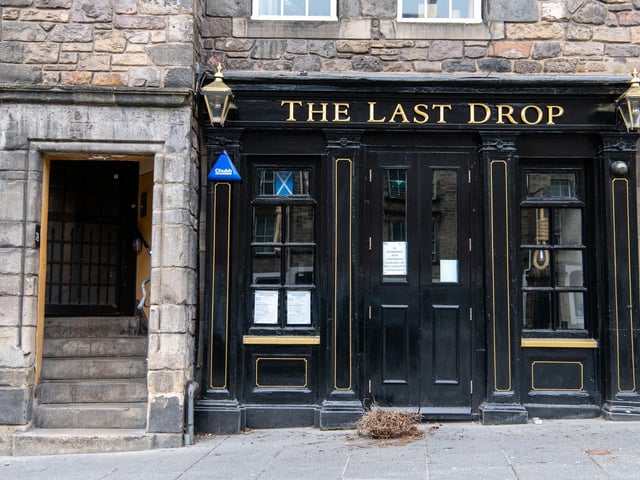 Eerie picture shows The Last Drop in Grassmarket, Edinburgh closed with posters on the windows alerting customers of its closure due to COVID-19