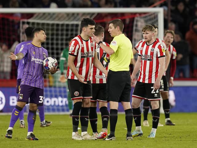 John Egan of Sheffield United is sent off by referee Matthew Donohue: Andrew Yates / Sportimage