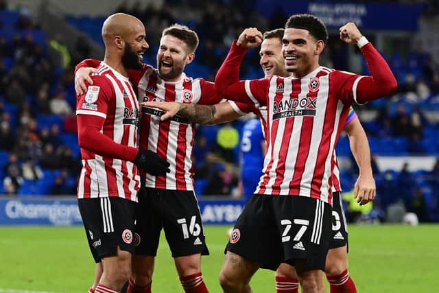 Sheffield United players, including Ollie Norwood, centre, celebrate scoring against Cardiff City
