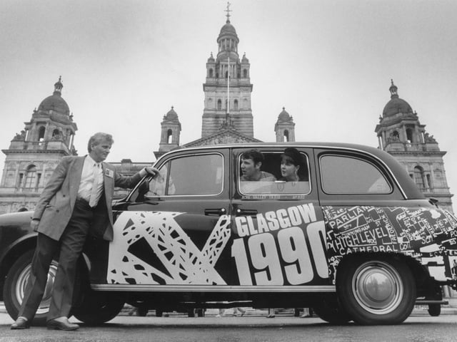 Barbara Scott and Brian Cairns, two artists of Glasgow School of Art with one of the 1990 taxis decorated by them as part of a scheme by the Festivals Office, with driver Jim McCourt in George Square.