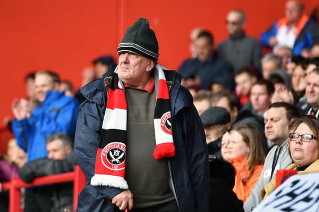 A Sheffield United fan shows his support in the stands at Bramall Lane before lockdown: Anthony Devlin/PA Wire