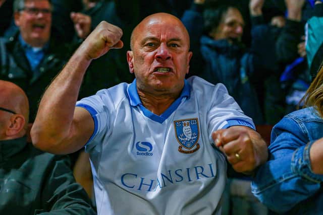 A Sheffield Wednesday fan celebrates an Owls goal in their win at Morecambe.