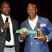 Evander Holyfield (L) is inducted into the Nevada Boxing Hall of Fame by Mike Tyson at the second annual induction gala at the New Tropicana Las Vegas. (Photo by Ethan Miller/Getty Images)