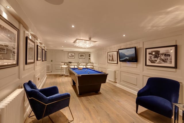 This spacious room is currently used as a bar and gaming area, and is fitted with built-in speakers, a TV aerial data point and recessed lighting, with oak doors leading into the cinemas room.