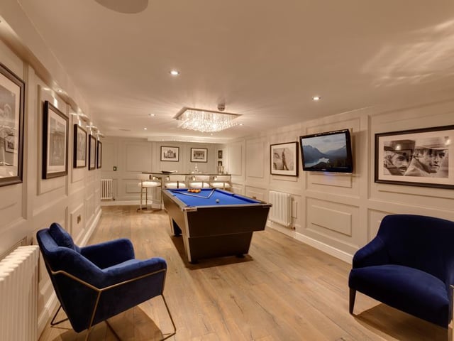 This spacious room is currently used as a bar and gaming area, and is fitted with built-in speakers, a TV aerial data point and recessed lighting, with oak doors leading into the cinemas room.
