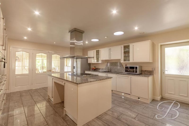 A wonderful kitchen, complete with a range of Miele appliances, gloss cabinets and units. It is complemented perfectly by its worktop and island.