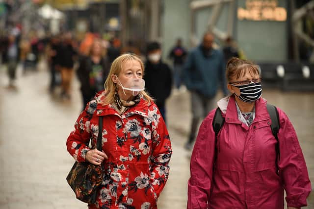 Women wearing face masks walk through the centre of Sheffield (Photo by Oli SCARFF / AFP) (Photo by OLI SCARFF/AFP via Getty Images)
