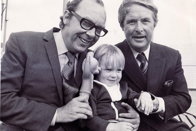 Morecambe and Wise hold a press conference at the Fiesta nightclub, Sheffield, and meet up with a young visitor to the city, Christopher John Tomlin, age 2, from Coal Aston. Pictured on September 17, 1971