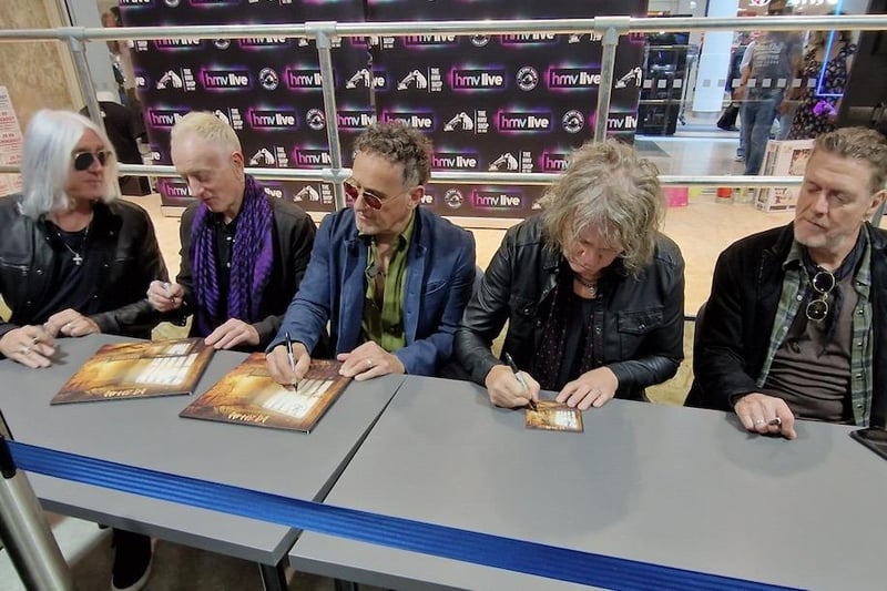Def Leppard hard at work signing albums for fans at HMV Meadowhall.