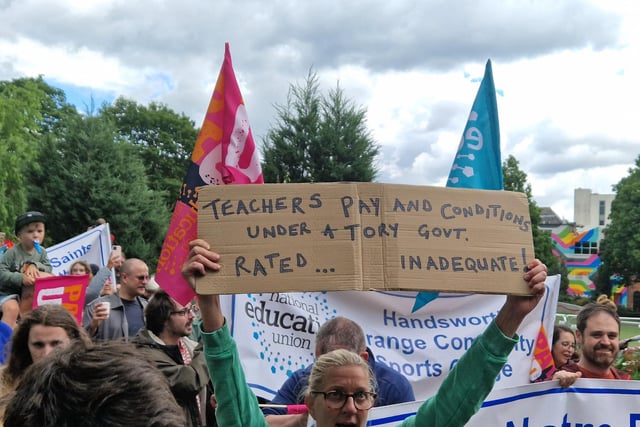 On the steps of City Hall, NEU member Rafia Hussain said schools were "inundated with box-ticking exercises to please Ofsted", which was met by boos from the crowd of teachers.