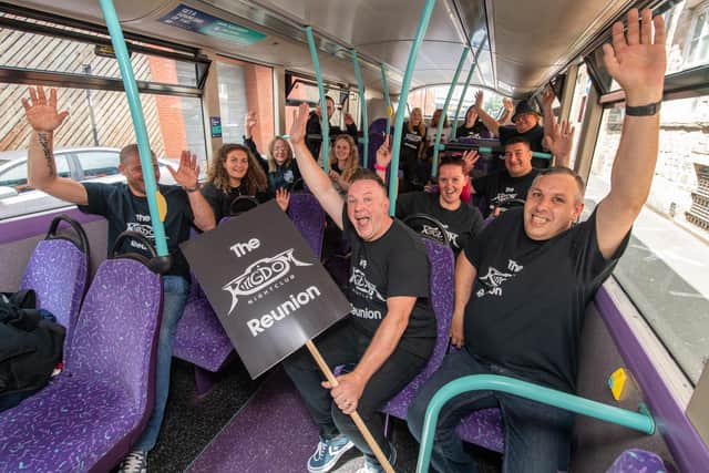 DJ Martin Wright, holding the placard, and clubbers on board the special First Bus Sheffield service that will be used for the Kingdom nightclub reunion at The Leadmill